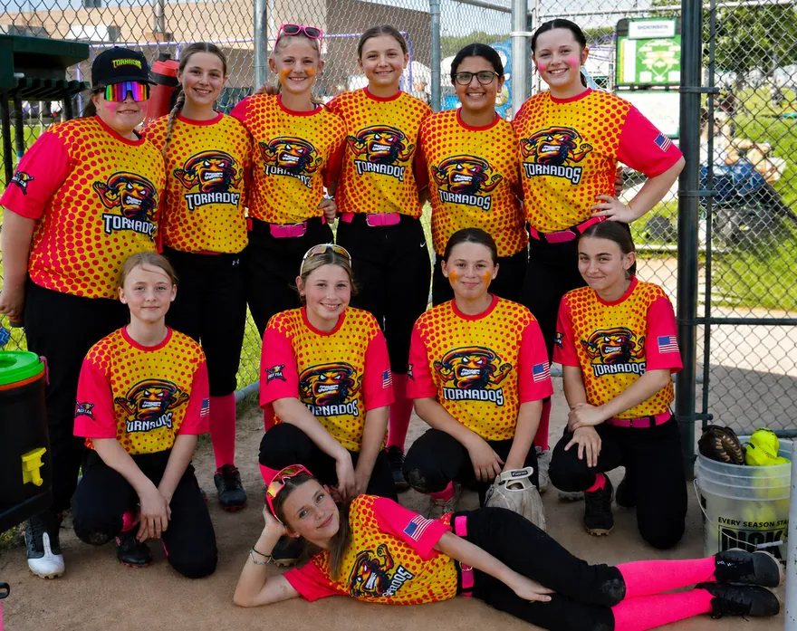 Youth softball team wearing yellow and pink halftone sublimated jerseys